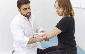Yleislääkäri Abdulsamet Simsek käyttää ultraääntä vastaanotollaan.